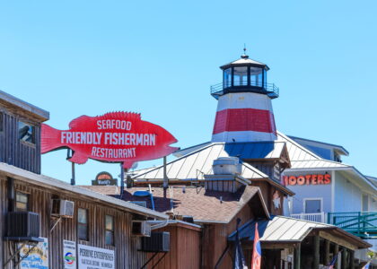 Johns Pass Village view of Friendly Fisherman and lighthouse from boardwalk.