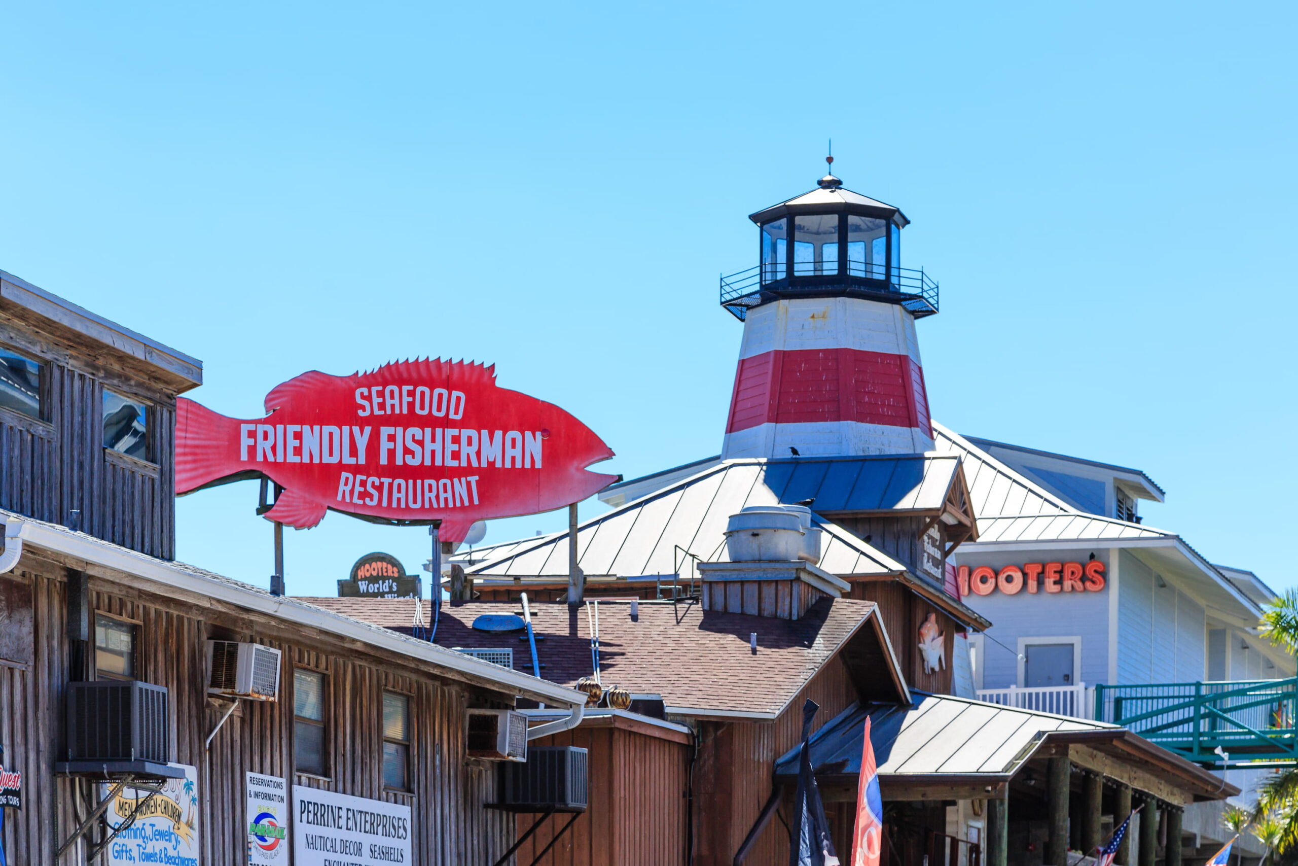 Johns Pass Village view of Friendly Fisherman and lighthouse from boardwalk.